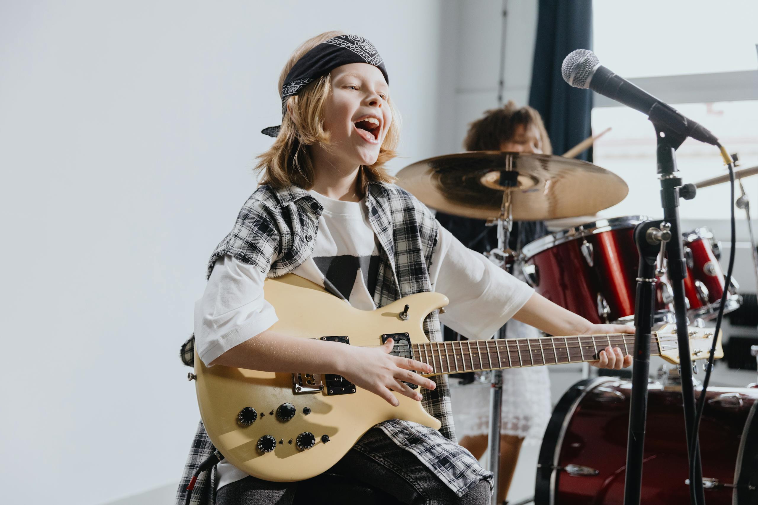 Energetic young kid playing electric guitar at an guitar lesson in Oakville.